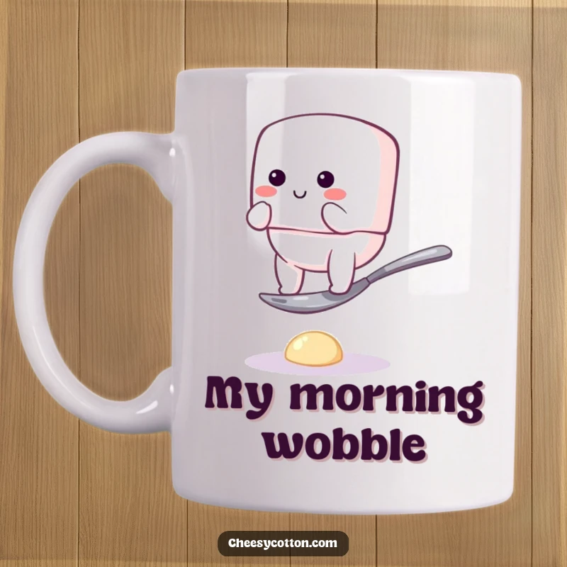Funny mug showcasing a bouncy marshmallow character hilariously failing to balance on a tiny spoon, full of clumsy charm and delightful humor.