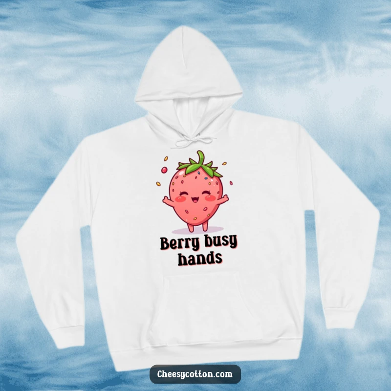 Funny Strawberry Sprinkle Hoodie: A cozy hoodie depicting a blushing strawberry character juggling three colorful sprinkles.