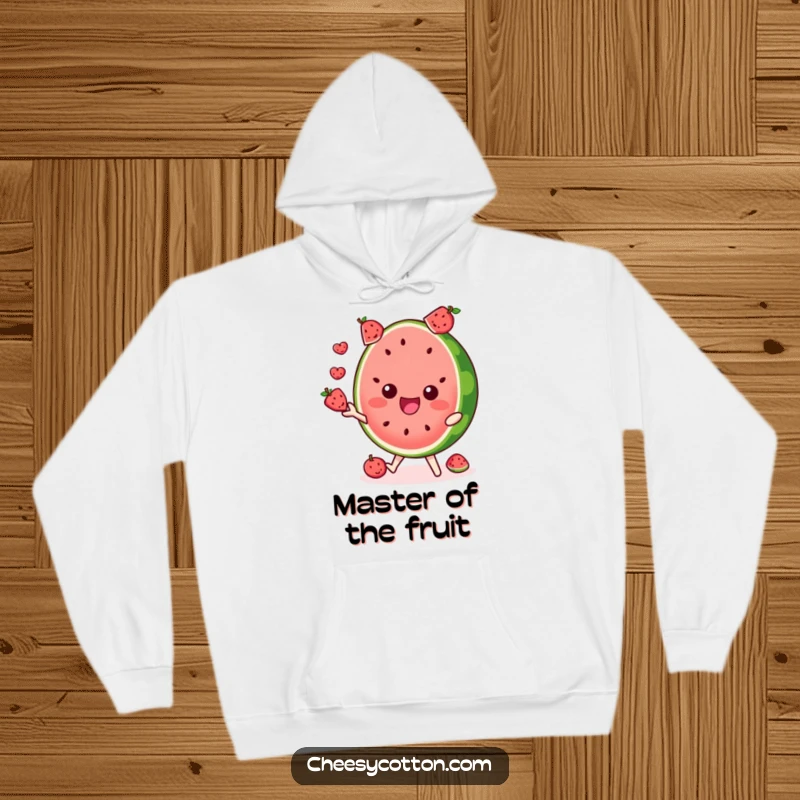 Funny hoodie showcasing a delighted watermelon slice character juggling tiny fruits, perfect for warmth.