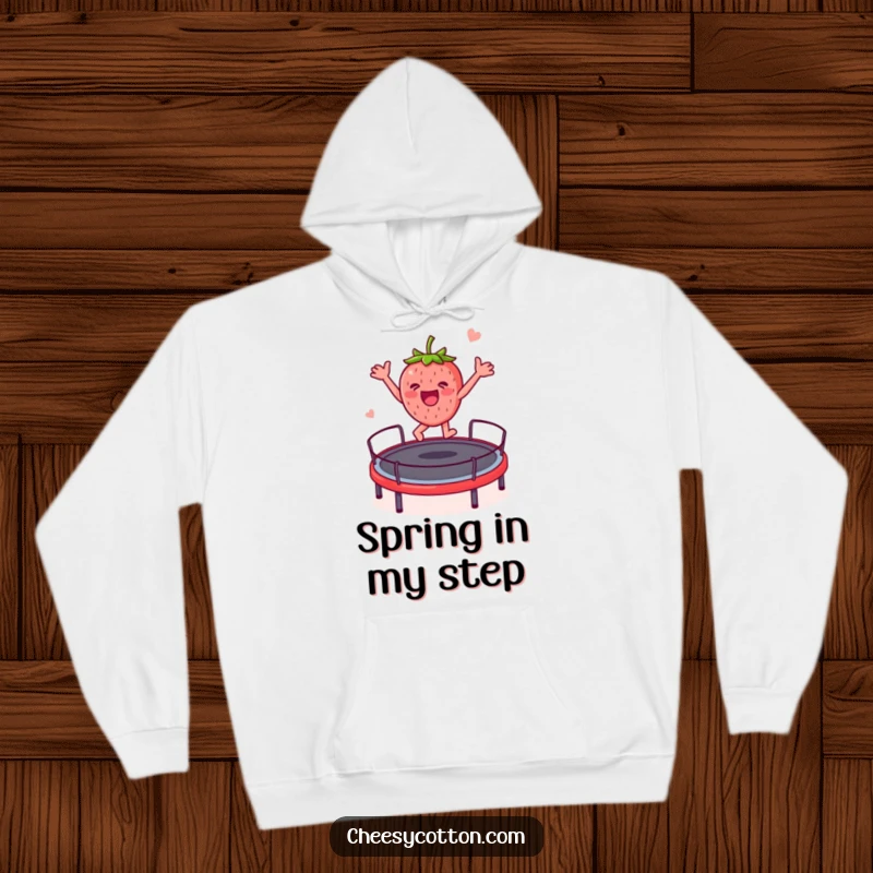 Funny strawberry character joyfully bouncing on a trampoline, printed on a comfortable hoodie for a humorous and warm feel.