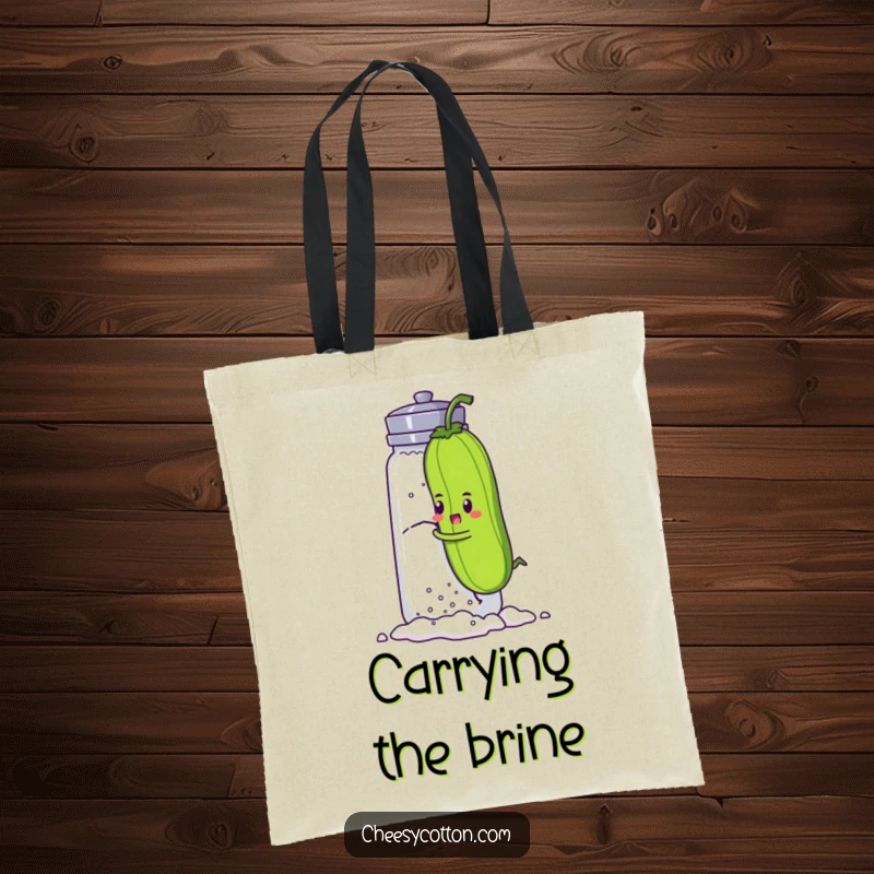 Funny tote bag with a determined pickle character attempting to climb a giant salt shaker, a humorous and practical accessory for daily life.